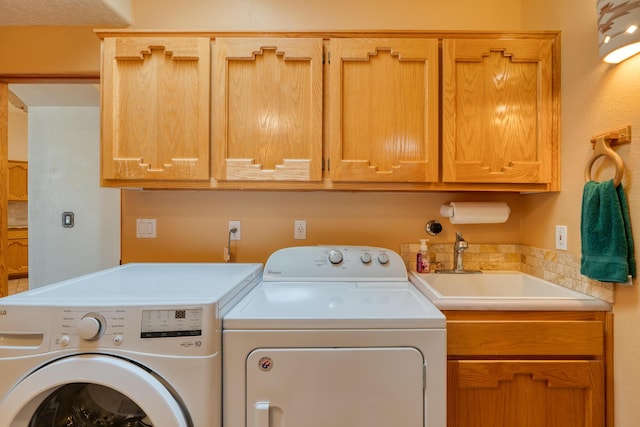 laundry area with a sink, cabinet space, and washer and dryer