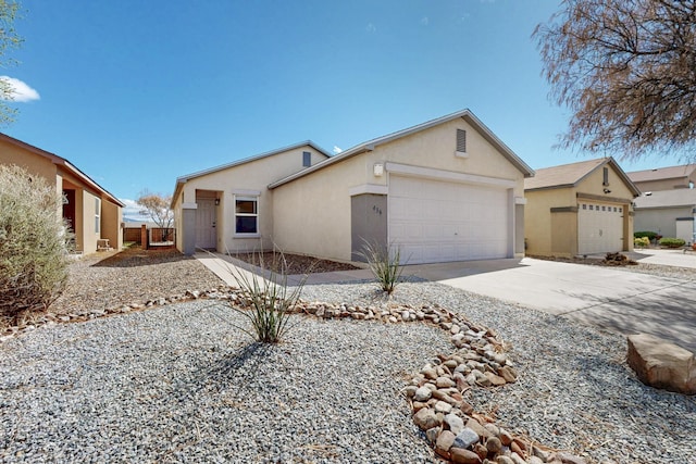 ranch-style house with an attached garage, driveway, and stucco siding