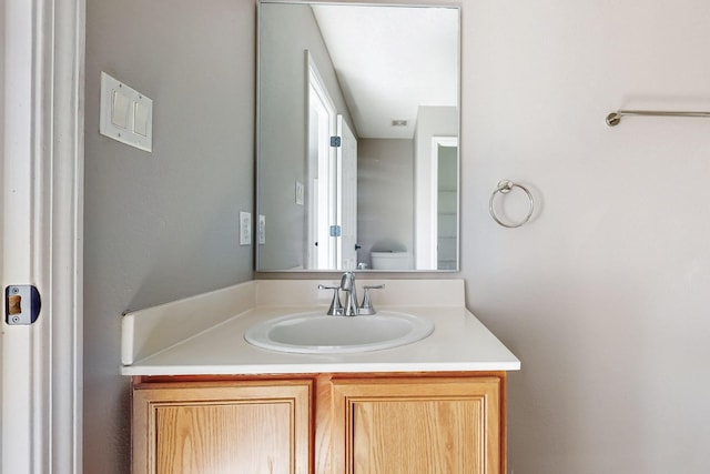 bathroom featuring vanity and toilet