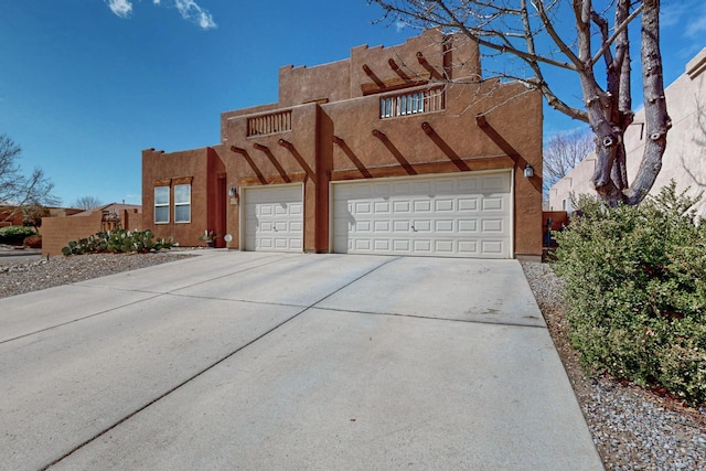 exterior space with stucco siding, driveway, and a garage