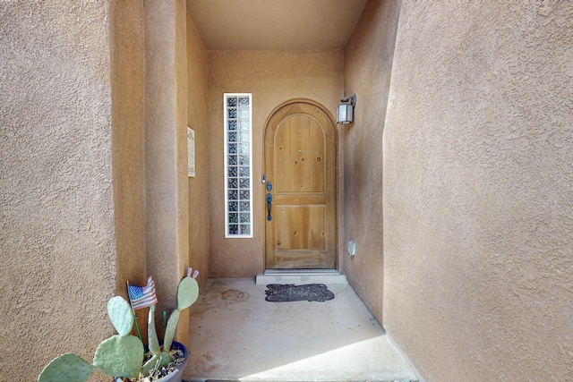 doorway to property with stucco siding