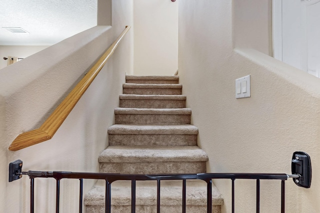 staircase with a textured wall