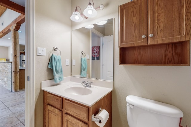 half bathroom with tile patterned floors, toilet, and vanity