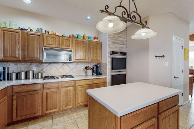 kitchen featuring tasteful backsplash, appliances with stainless steel finishes, and brown cabinets