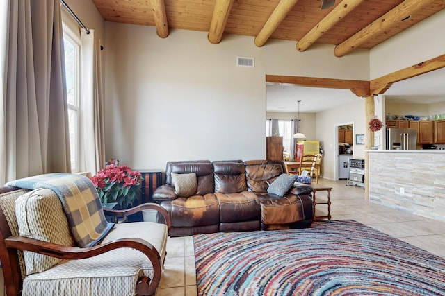 living room featuring beamed ceiling, light tile patterned floors, and wood ceiling