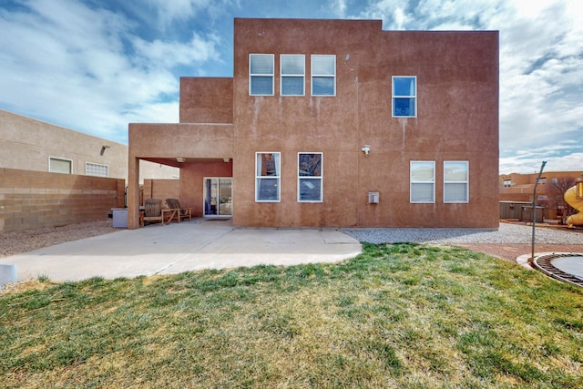 back of property featuring a patio, a fenced backyard, a lawn, and stucco siding