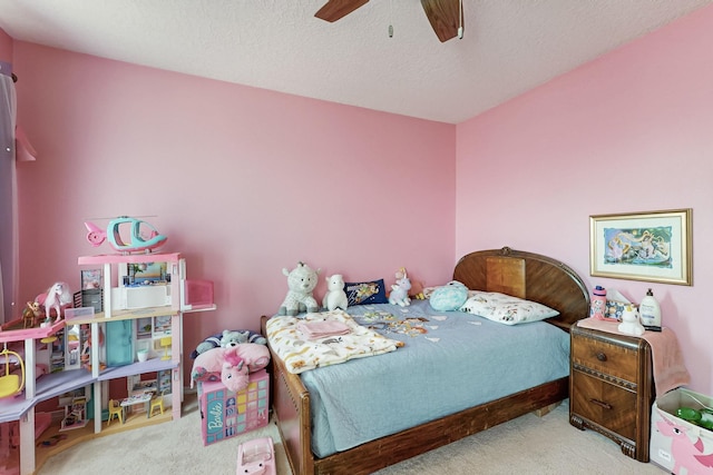 bedroom featuring ceiling fan, a textured ceiling, and carpet