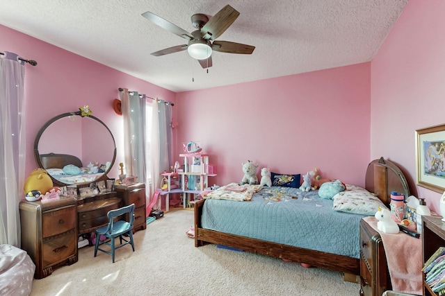 bedroom featuring a textured ceiling, ceiling fan, and carpet flooring