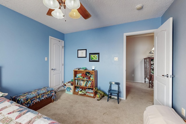 bedroom with carpet flooring, a textured ceiling, and a ceiling fan