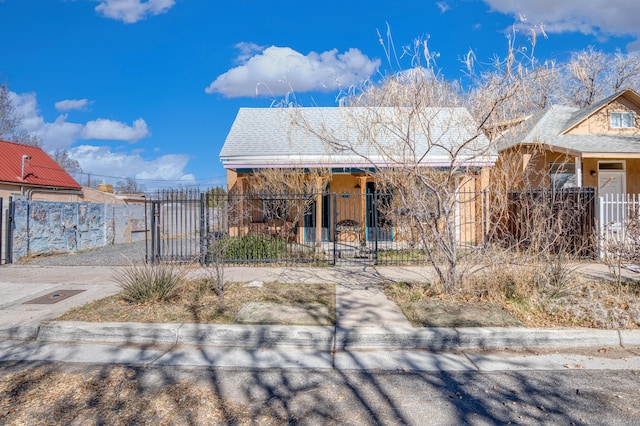 view of front of property with a fenced front yard and a gate