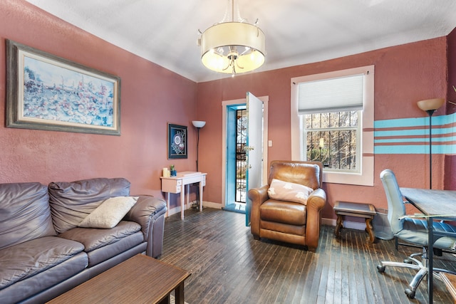 living area with baseboards and hardwood / wood-style floors