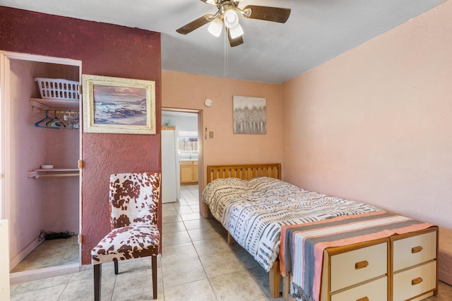 bedroom featuring light tile patterned flooring, a ceiling fan, and freestanding refrigerator