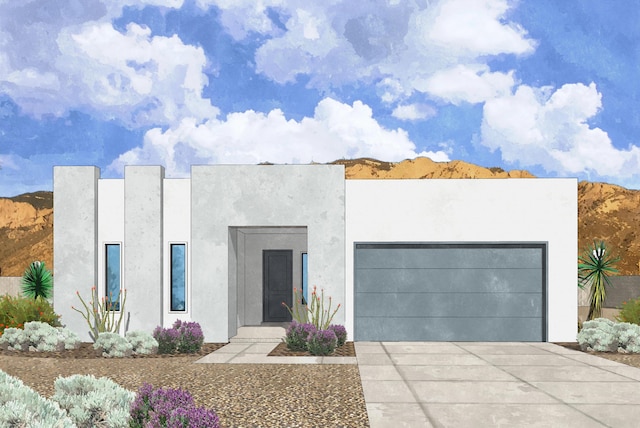 contemporary home featuring driveway, an attached garage, and stucco siding