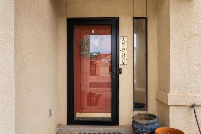 view of exterior entry with stucco siding