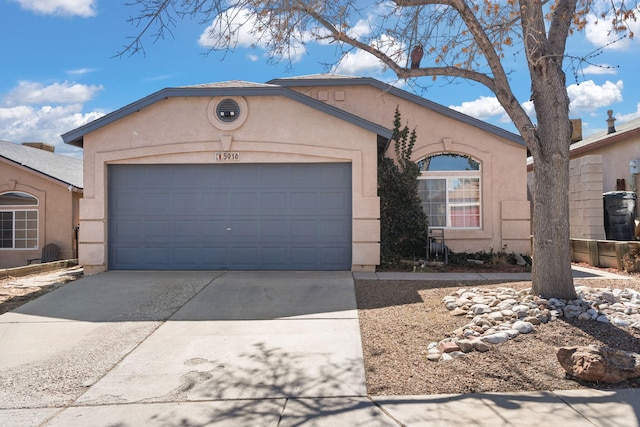 view of front of house featuring an attached garage, concrete driveway, and stucco siding