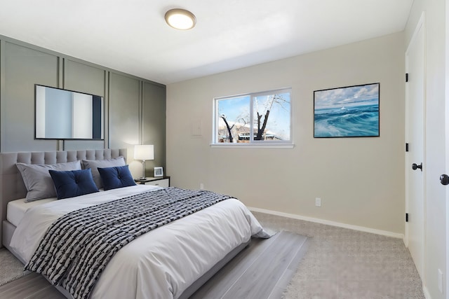 carpeted bedroom featuring baseboards