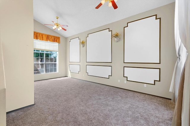 spare room featuring ceiling fan, lofted ceiling, and carpet floors