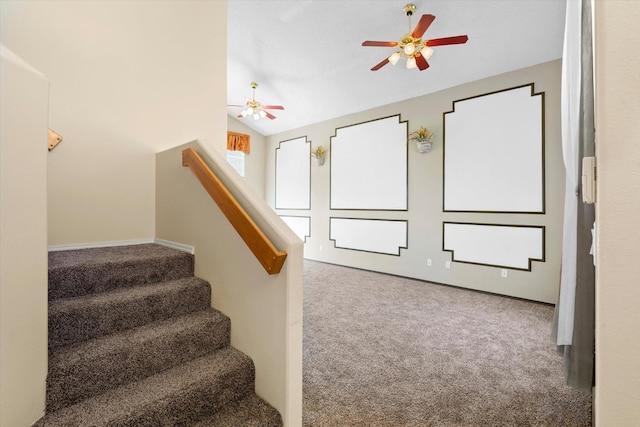 staircase featuring vaulted ceiling, a ceiling fan, and carpet floors