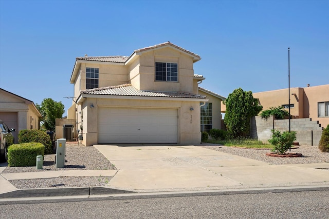 view of front of home featuring a tile roof, stucco siding, and concrete driveway