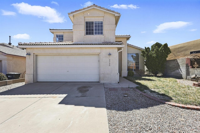 view of front of home with a tile roof, driveway, a garage, and stucco siding