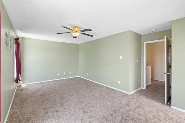 unfurnished room featuring a textured ceiling, baseboards, a ceiling fan, and carpet floors