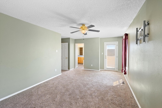 unfurnished bedroom with baseboards, a textured ceiling, light carpet, and a ceiling fan