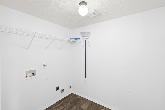 washroom featuring dark wood-type flooring, washer hookup, baseboards, gas dryer hookup, and laundry area