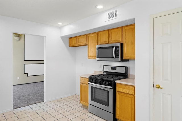 kitchen featuring recessed lighting, stainless steel appliances, visible vents, and light countertops