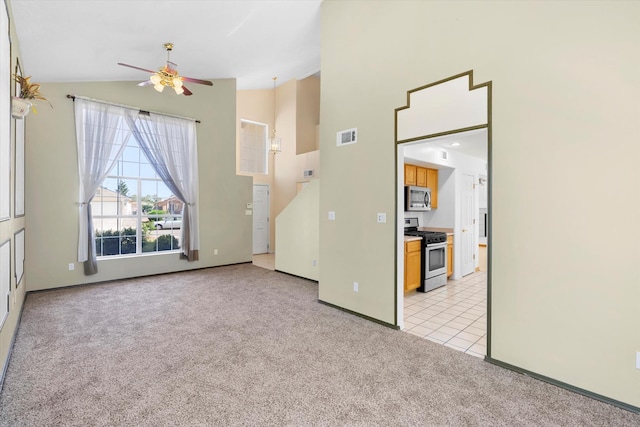 interior space featuring visible vents, light carpet, high vaulted ceiling, and light tile patterned flooring