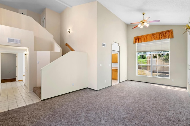 interior space with stairs, high vaulted ceiling, visible vents, and light carpet