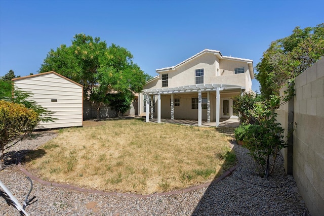 back of house with an outbuilding, a pergola, a fenced backyard, a shed, and a patio area