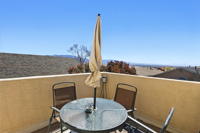 balcony with a mountain view and outdoor dining space