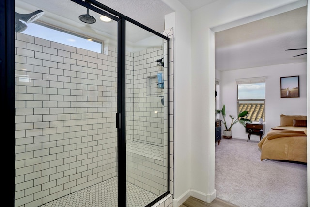 bathroom with a stall shower, baseboards, and ensuite bathroom