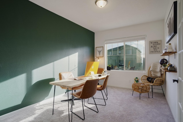 carpeted home office featuring baseboards