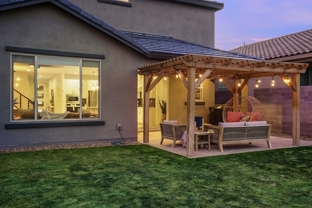 rear view of house featuring a patio, fence, a lawn, stucco siding, and a pergola