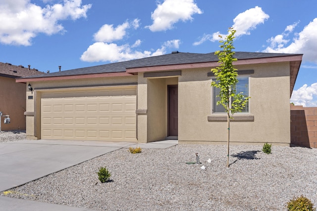 view of front of house featuring fence, a garage, driveway, and stucco siding