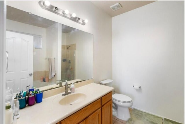 full bath with visible vents, toilet, a shower stall, vanity, and tile patterned floors