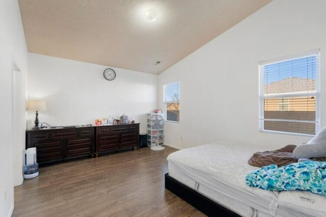 bedroom featuring vaulted ceiling and wood finished floors