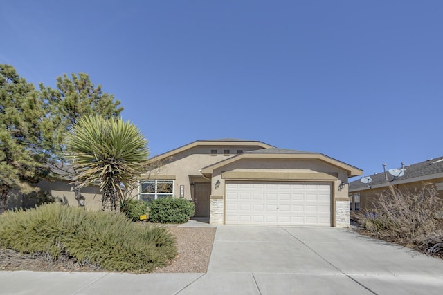 view of front of property featuring stucco siding, stone siding, a garage, and driveway