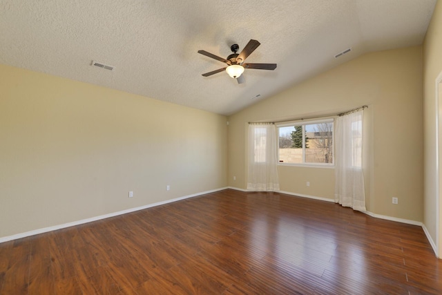 empty room with ceiling fan, visible vents, lofted ceiling, and wood finished floors