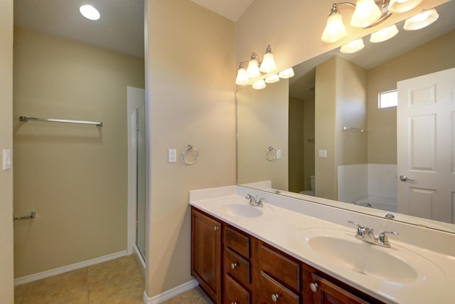 full bathroom with a sink, a garden tub, double vanity, and toilet