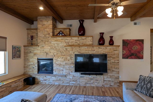 living area with visible vents, a fireplace, wood ceiling, and wood finished floors