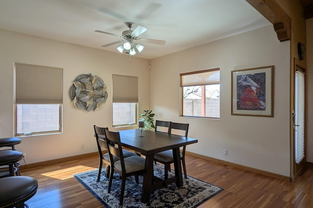 dining area with ceiling fan, baseboards, and wood finished floors