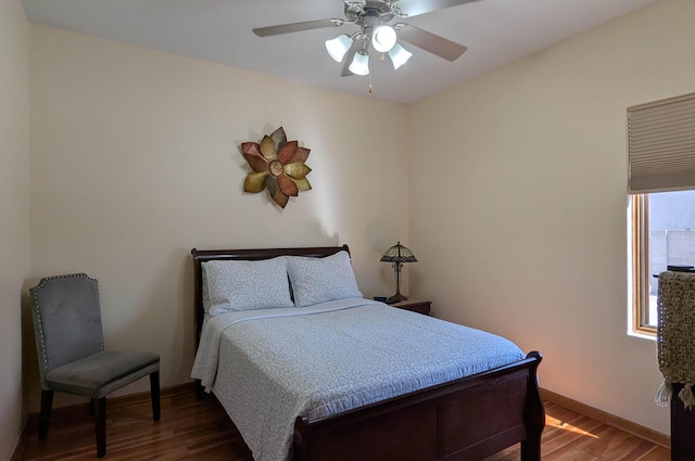 bedroom with baseboards, dark wood-style flooring, and ceiling fan