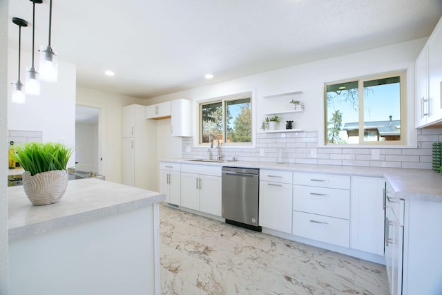 kitchen featuring stainless steel dishwasher, decorative backsplash, marble finish floor, and a sink