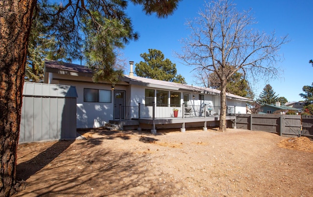 ranch-style house with stucco siding and fence