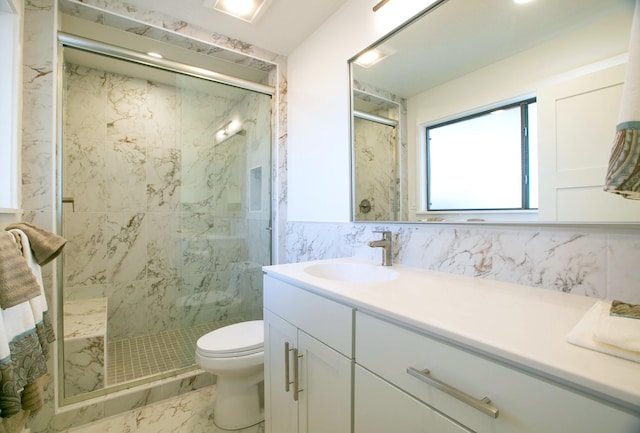 bathroom with toilet, marble finish floor, a marble finish shower, tile walls, and vanity