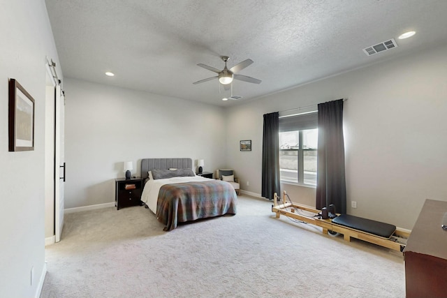 carpeted bedroom featuring visible vents, recessed lighting, baseboards, and a barn door