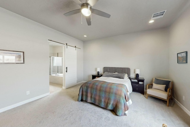 bedroom with visible vents, baseboards, a barn door, light carpet, and recessed lighting