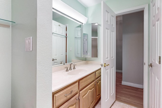 bathroom featuring baseboards and vanity